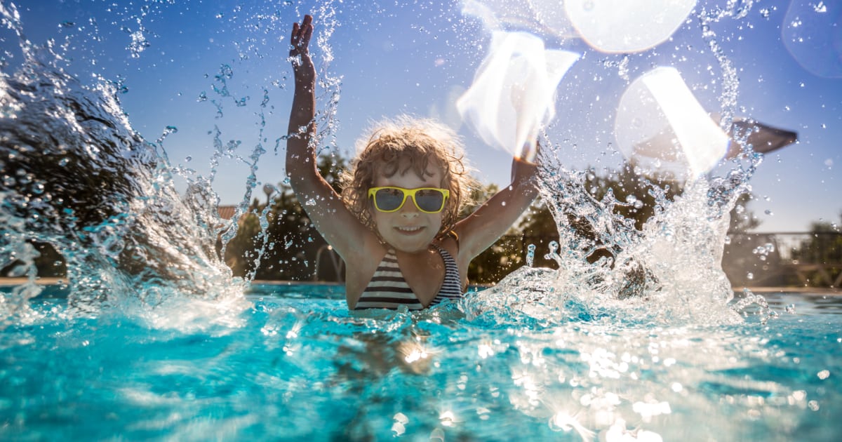 Child playing in swimming pool Happy child playing in swimming pool.