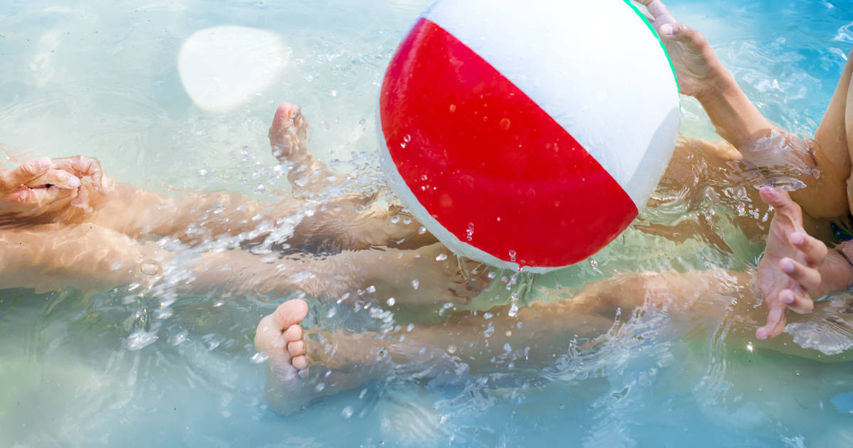 Kids playing in swimming pool Kids playing at outdoor swimming pool. Little girl and boy play and swim in a home inflated pool .Water toys for children. Concept for summer vacations, relaxation and fun in the sunshine