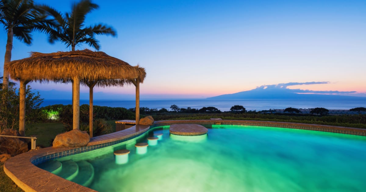 Luxury home with swimming pool Luxury home with swimming pool lit up at sunset.